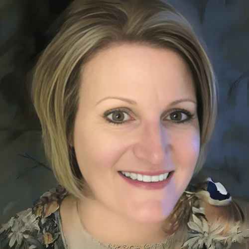 Smiling woman with short blonde hair and friendly brown eyes wearing a flowered blouse complementing her natural aesthetic and inviting expression.